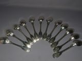 a lot of spoons arranged in a circle on a table