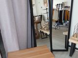 a mirror and a bench in the corner of a room