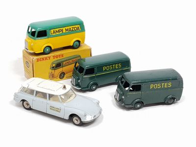 three toy cars sitting next to each other on a white surface