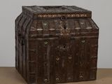 a wooden chest with a lock on it on a table