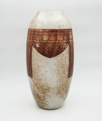 a brown and white vase on a white background