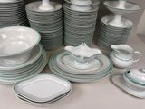 a lot of plates and bowls on the table