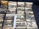several old black and white photographs of people and vehicles on a table