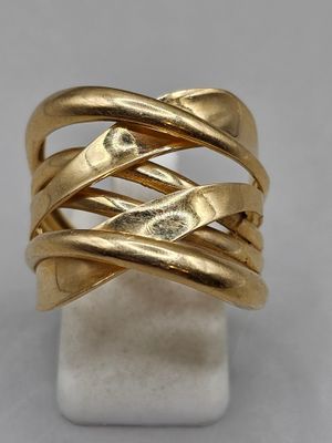 a close up of a gold ring on a marble block