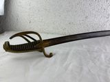 a sword that is laying on a white surface
