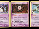 three cards with different designs of eyes on them on a black background