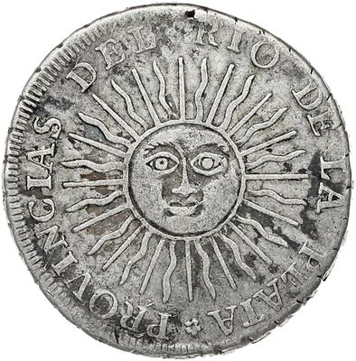 a close up of a coin with a sun on it