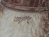a large vase with writing on it sitting on a table