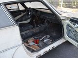 a white car with a bunch of tools inside of it