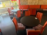 tables and chairs in a restaurant with balloons and balloons in the background