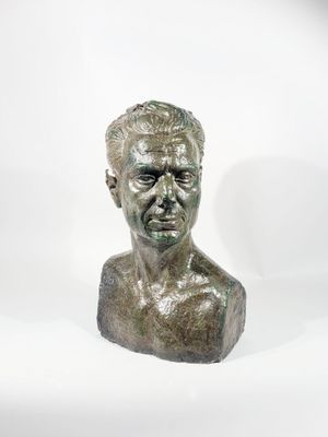 a close up of a bronze bust of a man on a white background