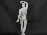 a white statue of a man holding a tennis racquet on a black background