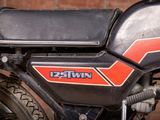 a close up of a motorcycle parked in front of a brick wall