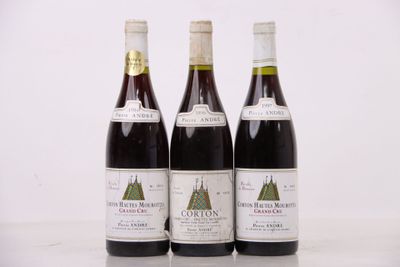 trois bouteilles de vin sont alignées sur une table