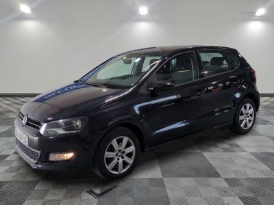 the black volkswagen polo estate is parked on a checkered tile floor