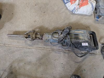 an image of a drill and other tools on the floor