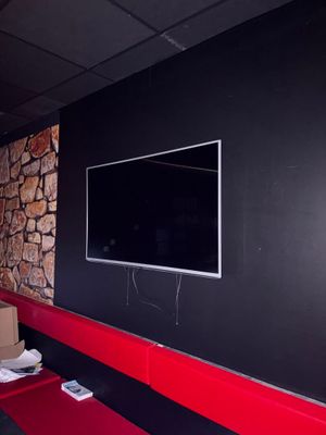 un téléviseur à écran plat fixé au mur d'une pièce