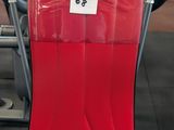 a red scooter with a sticker on it in a gym