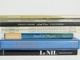 five books stacked on top of each other on a table