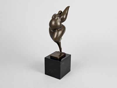 a bronze statue of a woman on a black pedestal