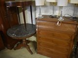 two lamps and a table with a marble top in a room