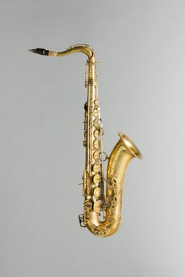 un gros plan d'un saxophone doré sur fond blanc