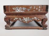a small wooden box with a floral design on it