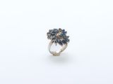 a close up of a silver ring with blue stones on it
