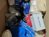 a cardboard box filled with clothes and other items