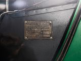 a plaque on the side of an old green car
