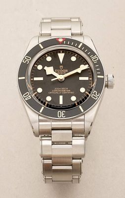 an image of a watch with a black dial on a silver bracelet