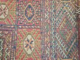 a close up of a rug on a table next to a wall