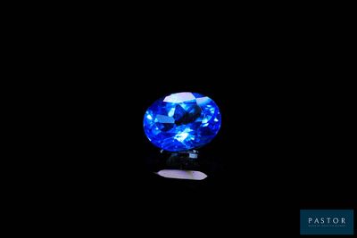 a blue sapphire stone on a black background