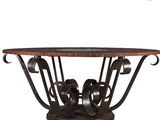 a round table with a glass top and metal legs