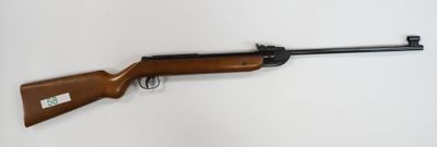 a rifle on a wall with a white background
