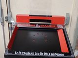 a red table with a sign on it that says le plus grand jeu de boule au monde