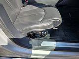 the interior of a car with the door open and the driver seat down