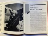 an open book with a black and white photo of a man on a plane