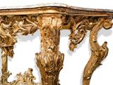 a wooden table with a marble top and ornate carvings on it