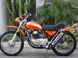 an orange motorcycle parked in front of a building