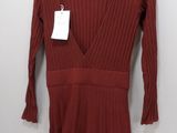 a red dress hanging on a hanger with a tag on it
