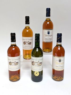 four bottles of wine sitting next to each other on a white surface