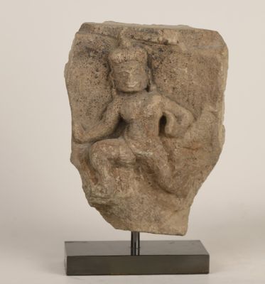 an image of a stone sculpture of a woman sitting on a rock