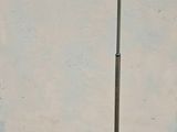 a floor lamp that is on the ground next to a wall