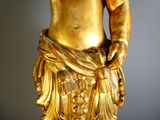 a gold statue of a man with a hat on