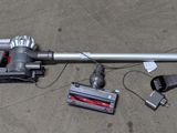 a vacuum that is laying on the ground next to other items