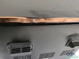 a close up of a metal grill with a copper foil covering it