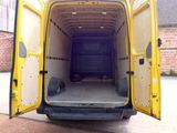 a yellow van with its doors open on the street