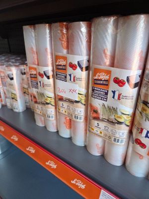 many rolls of food on the shelf in the store