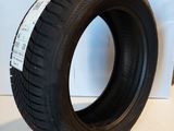 a close up of a tire on a white surface next to a wall